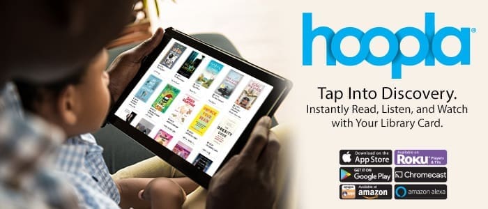 young boy with parent looking at a tablet screen with items available for download through Hoopla
